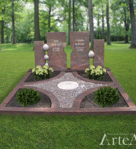 Dubbelgraf van rood graniet met verschillende bollen en tuin met planten