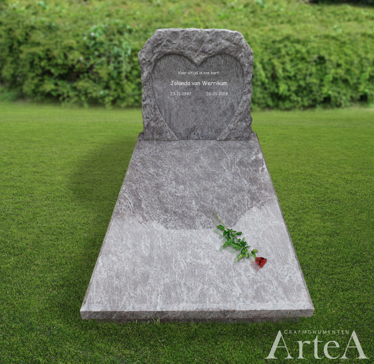 Grafmonument met hart uitgekapt uit ruw graniet en een roos